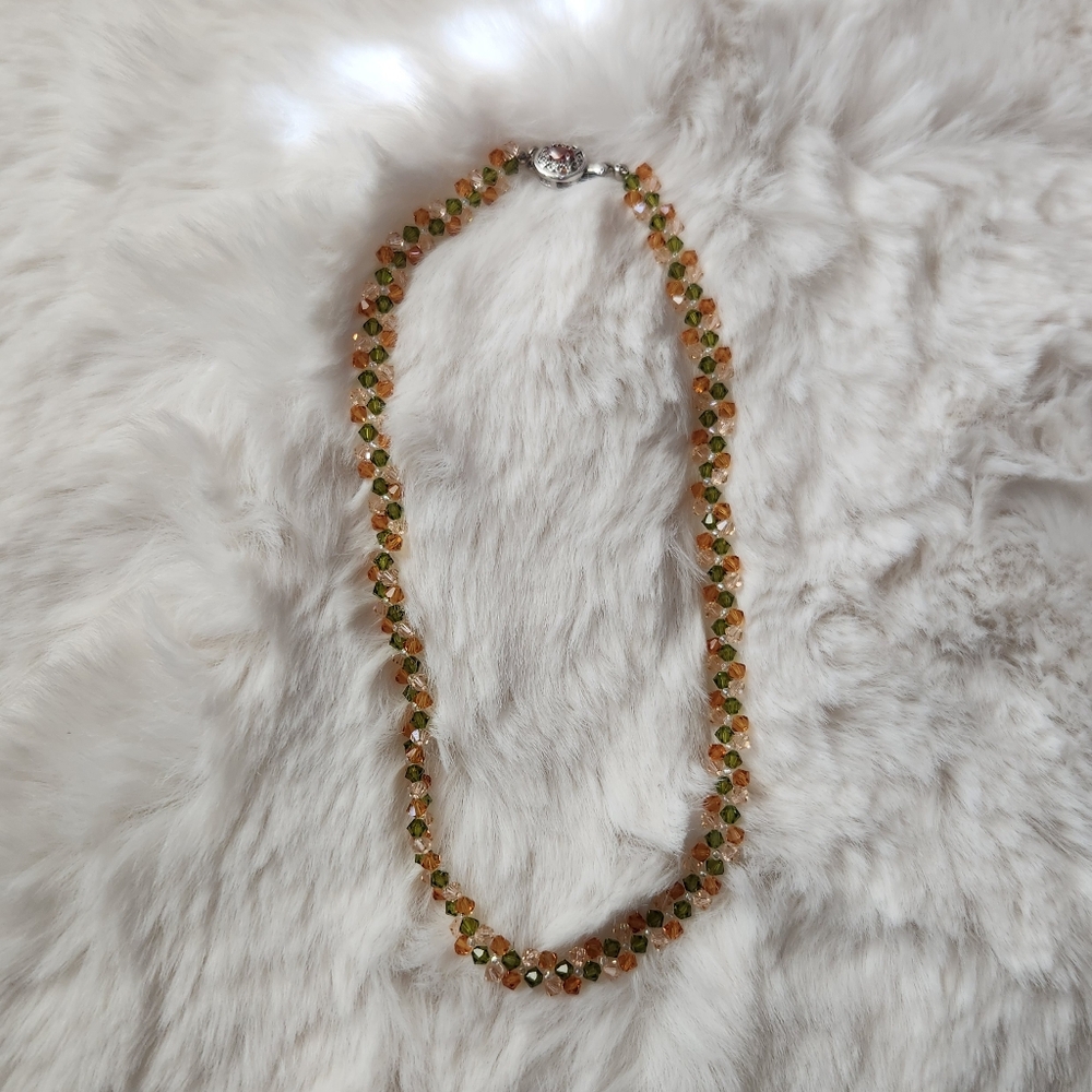 Handmade green and orange beaded necklace with a silver with orange crystal